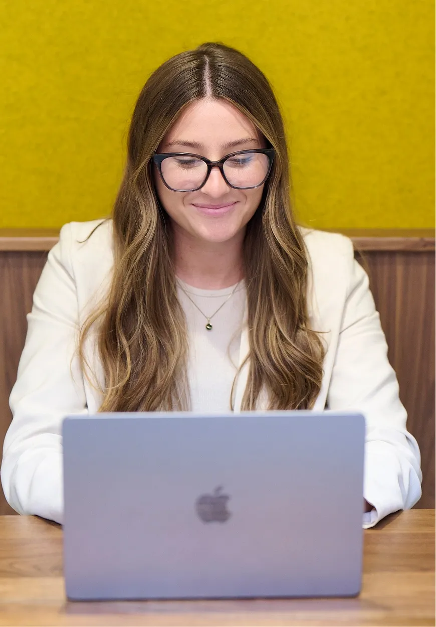 Team member working on a laptop at a desk